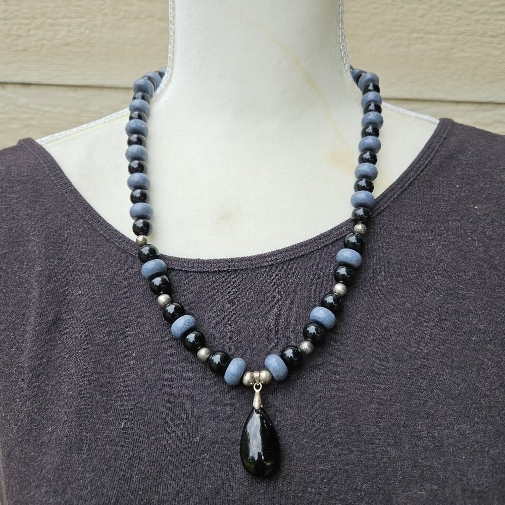 blue and black beaded necklace with black teardrop pendant